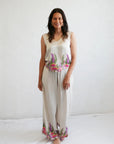 Model wearing the relaxed-fit Bobbi V-neck short-sleeve top in silky Princess Gum print showcasing vibrant First Nations abstract art.