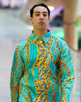 Medium close-up of a male model wearing the Kirrikin Karijini unisex shirt, highlighting the collar structure and vibrant turquoise Indigenous artwork by Sally White.