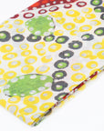 Close-up of the Blooming Sturt Peas cashmere scarf showing soft textile weave, warm golden tones, and detailed Pilbara Sturt pea artwork.