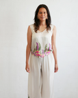 Front view of the Kirrikin Bobbi V-Neck Top in Princess Gum premium viscose satin featuring colorful Indigenous artwork by Buffie Punch.