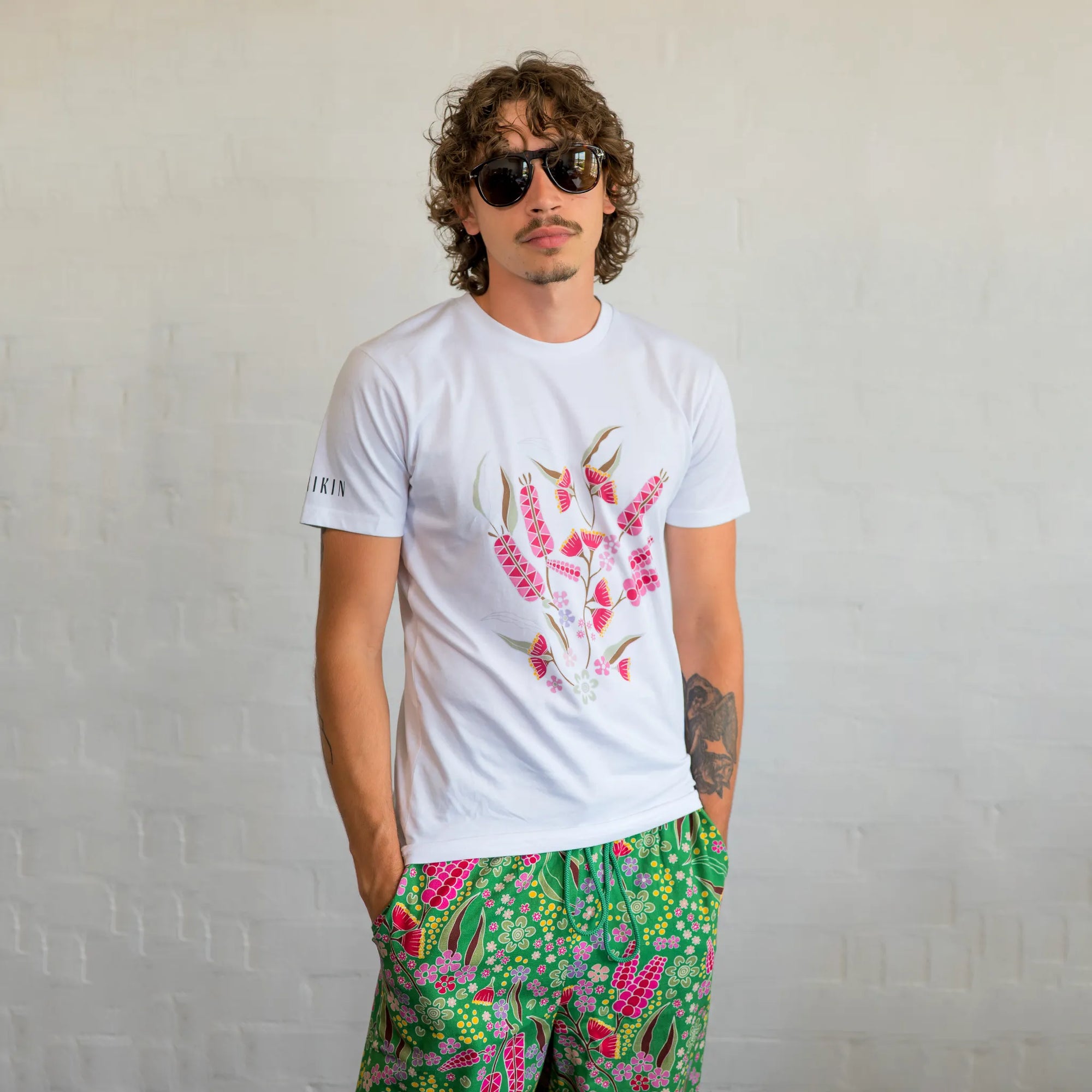 Model wearing a unisex black Boodja t-shirt styled in a relaxed, gender-neutral fit against a minimalist background.