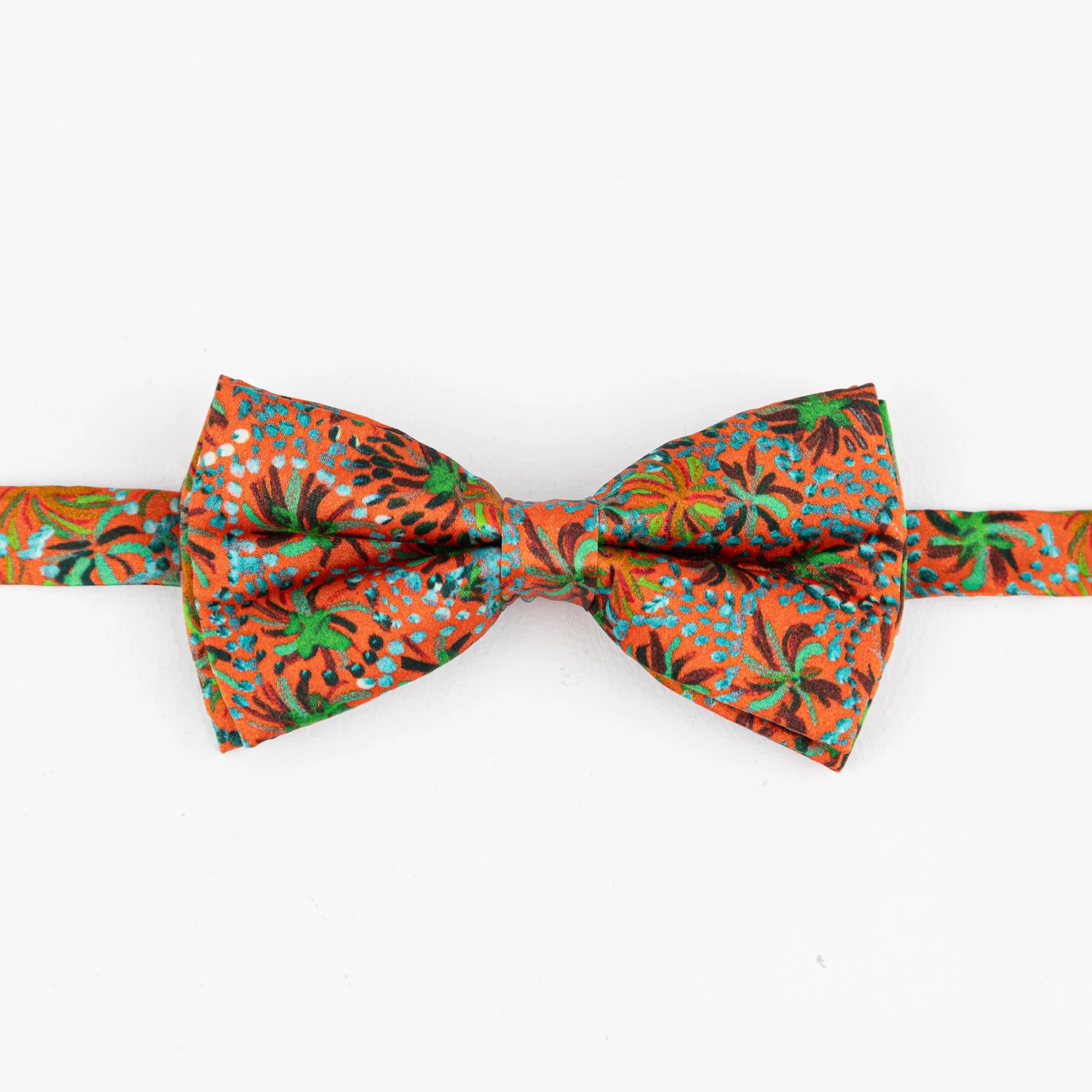 Kirrikin Exmouth printed silk bow tie styled as a formal luxury accessory highlighting authentic Aboriginal art design.