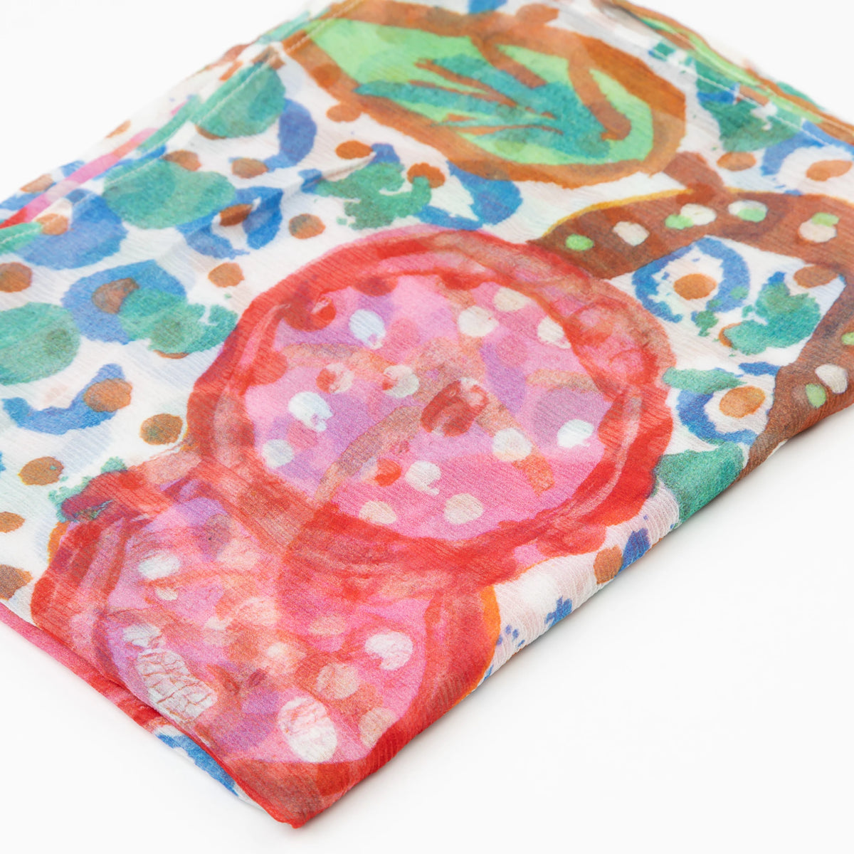 Close-up of the folded Bushtucker luxury cashmere scarf by Sally White featuring a colorful artwork print.