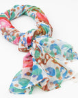 Bushtucker luxury cashmere scarf designed by Sally White tied in a loose knot against a white background.