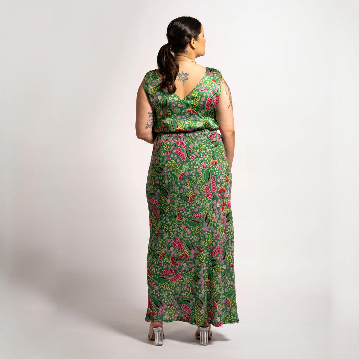 Back view of model styled in the green botanical print Jenni maxi skirt and matching sleeveless V-neck top.