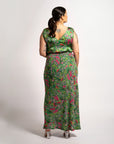 Back view of model styled in the green botanical print Jenni maxi skirt and matching sleeveless V-neck top.