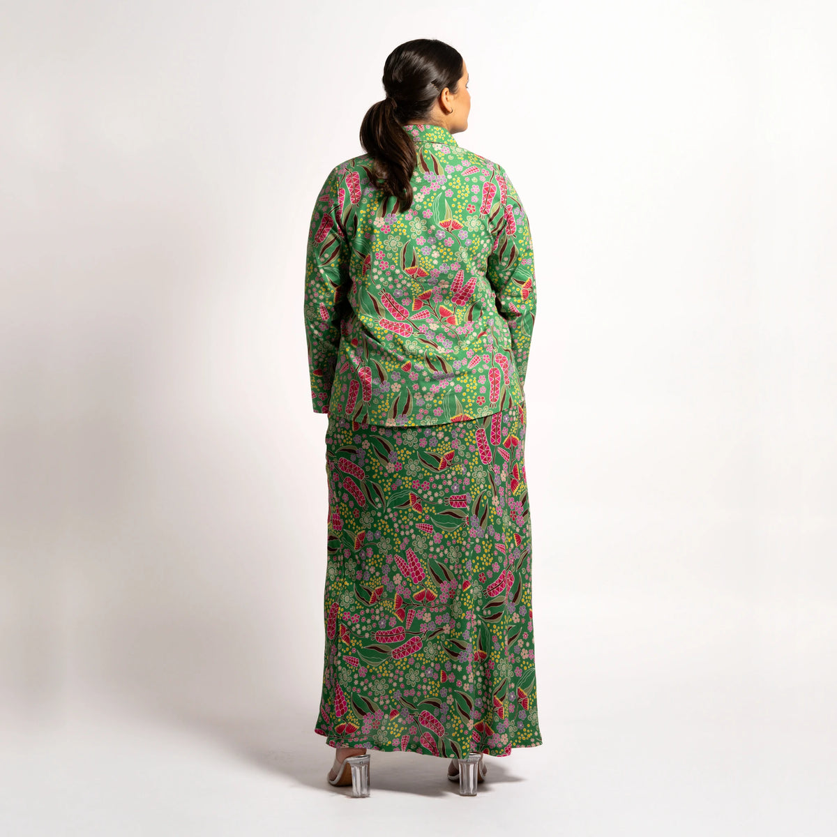 Back view of model wearing the long sleeve green printed top paired with the Jenni maxi skirt set.