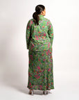 Back view of model wearing the long sleeve green printed top paired with the Jenni maxi skirt set.