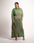 Front view of model wearing the green printed Jenni maxi skirt with a long sleeve button-up shirt set.