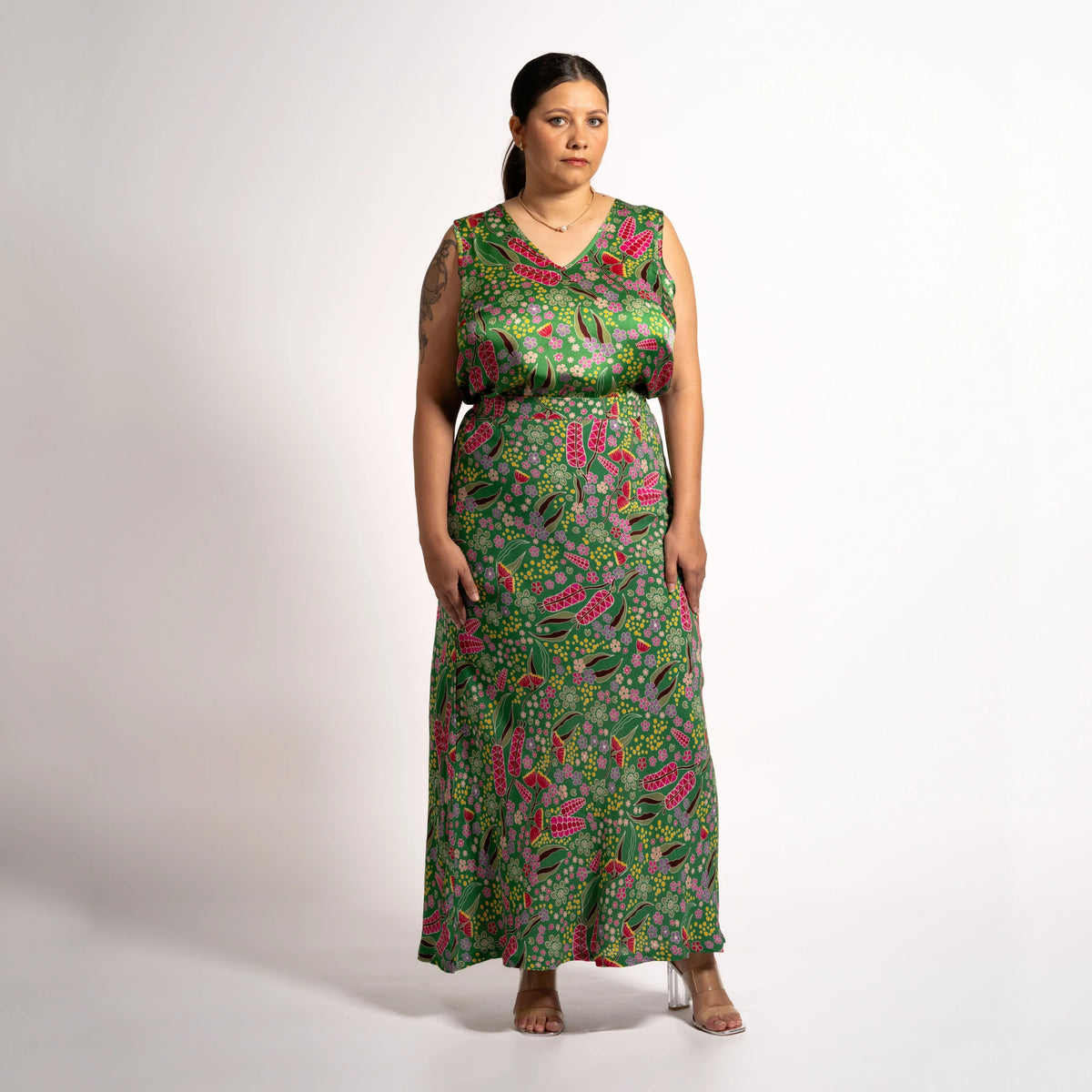Front view of model wearing the green floral Jenni maxi skirt and matching sleeveless V-neck top set.