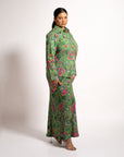 Side profile view of model wearing the green patterned Jenni maxi skirt and long sleeve blouse set.