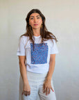 Women model wearing a casual Pilbara Wildflowers t-shirt styled with denim jeans in a natural outdoor setting.