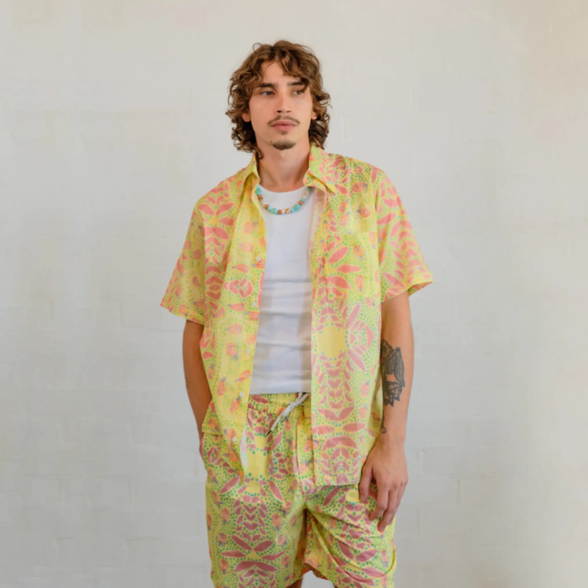 Collar and button detail on the Kirrikin men's Honey Ants short sleeve shirt with Indigenous artwork.