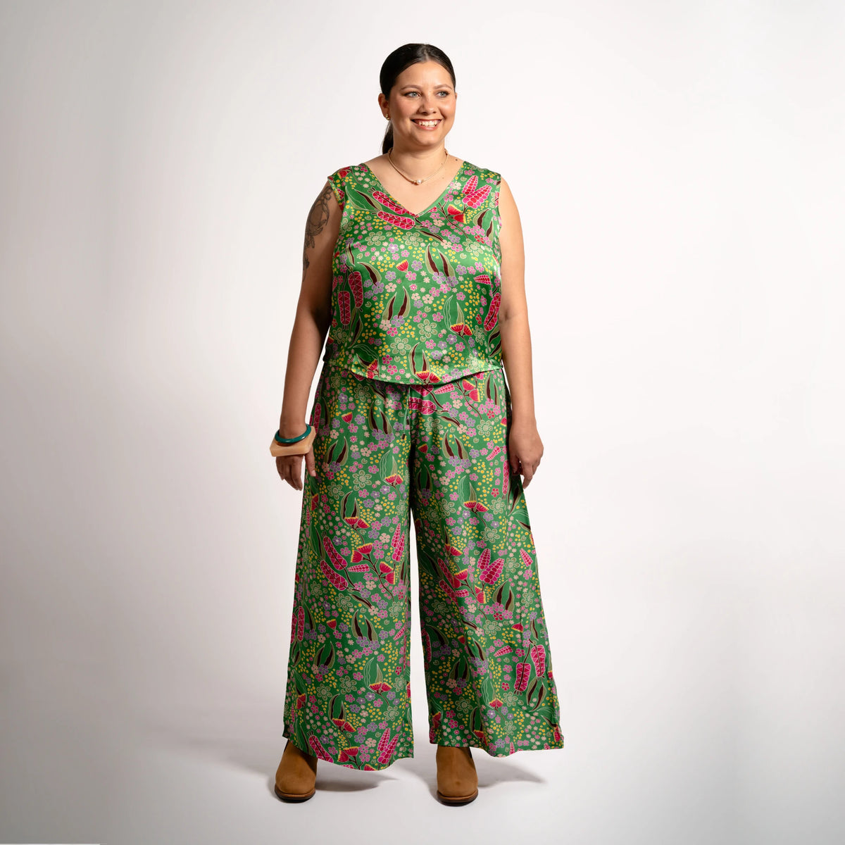 Front full-body shot of a model wearing wide-leg Sophie Pants Boodja in green Viscose Crepe with Indigenous flora pattern from the Evoke Collection.