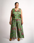Front full-body shot of a model wearing wide-leg Sophie Pants Boodja in green Viscose Crepe with Indigenous flora pattern from the Evoke Collection.