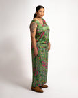 Full side profile view highlighting the flowing fit and vibrant Indigenous pattern of the green Sophie Pants Boodja.