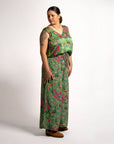 Three-quarter side angle of model wearing relaxed-fit green wide-leg pants featuring Boodja floral print and comfortable elastic waistband.
