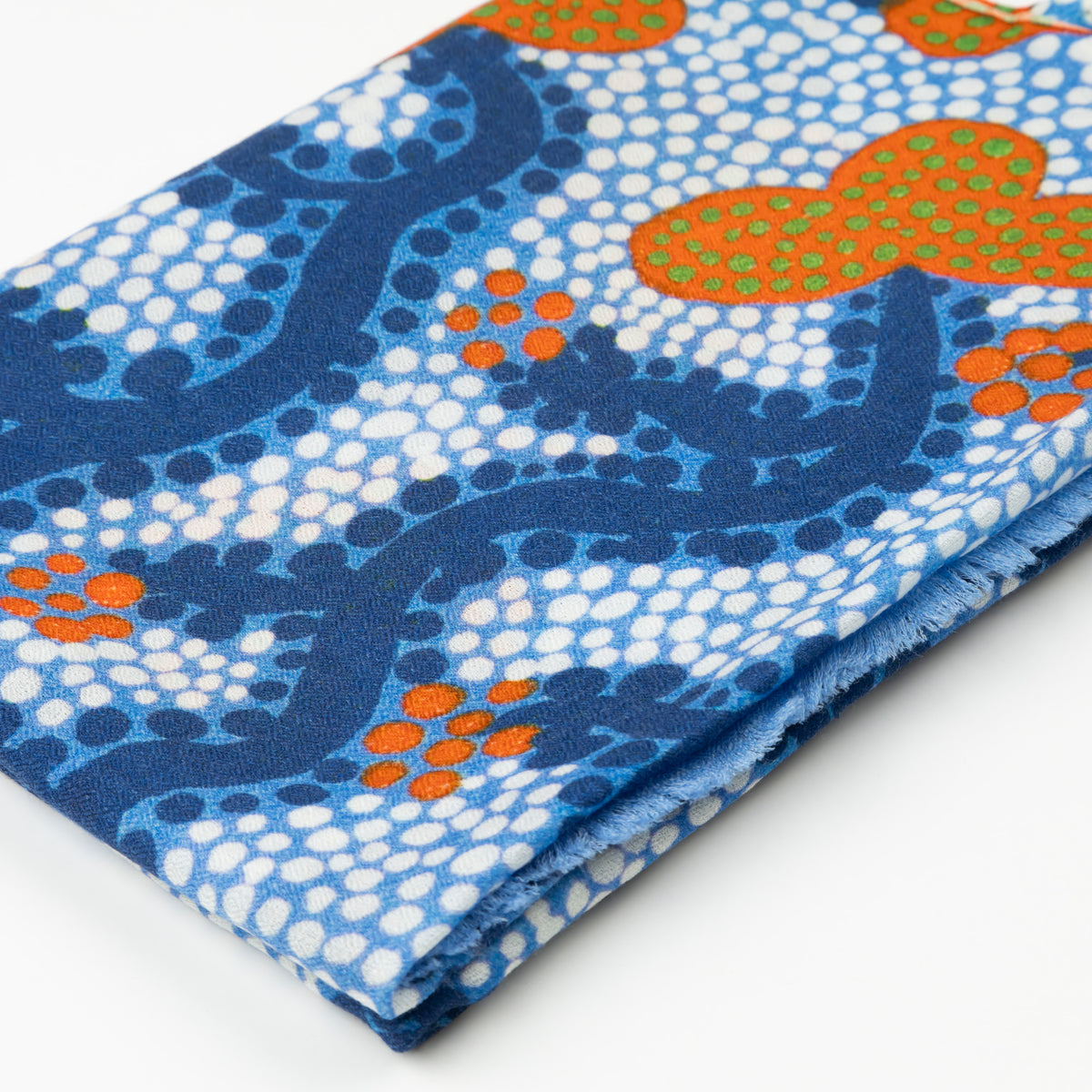 Close-up of folded Split Jack 100% Cashmere Scarf showing the detailed blue, white, and orange Indigenous art pattern by Kaye White.