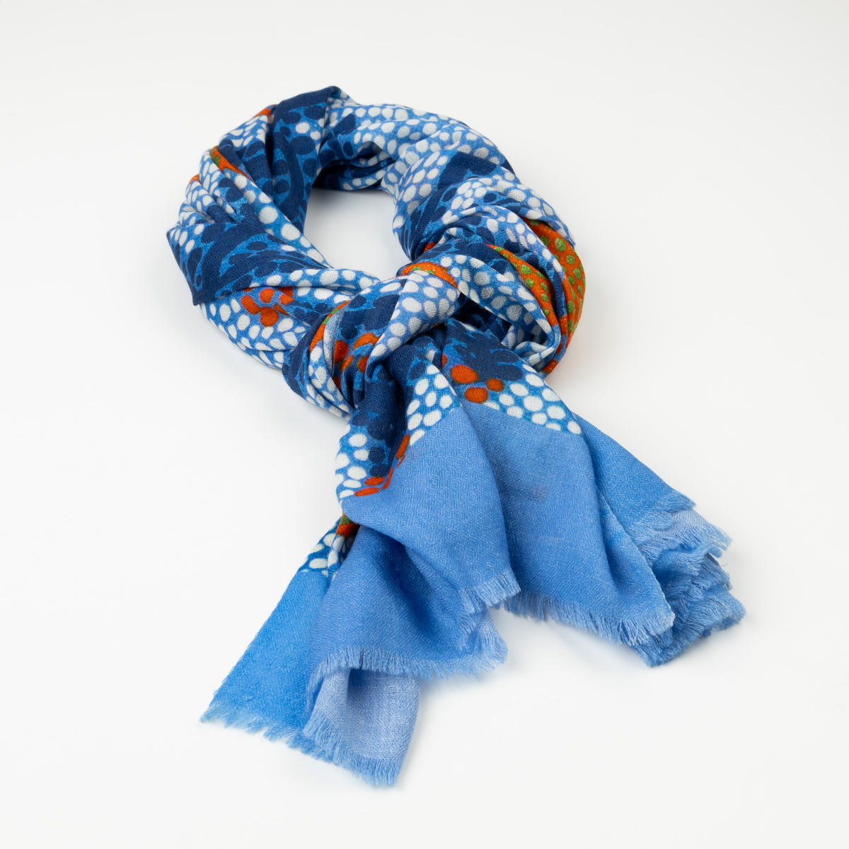 Kirrikin Split Jack Luxury Cashmere Scarf styled in a loose knot on a white background, featuring blue, orange, and white Indigenous dot artwork by Kaye White with frayed edges.