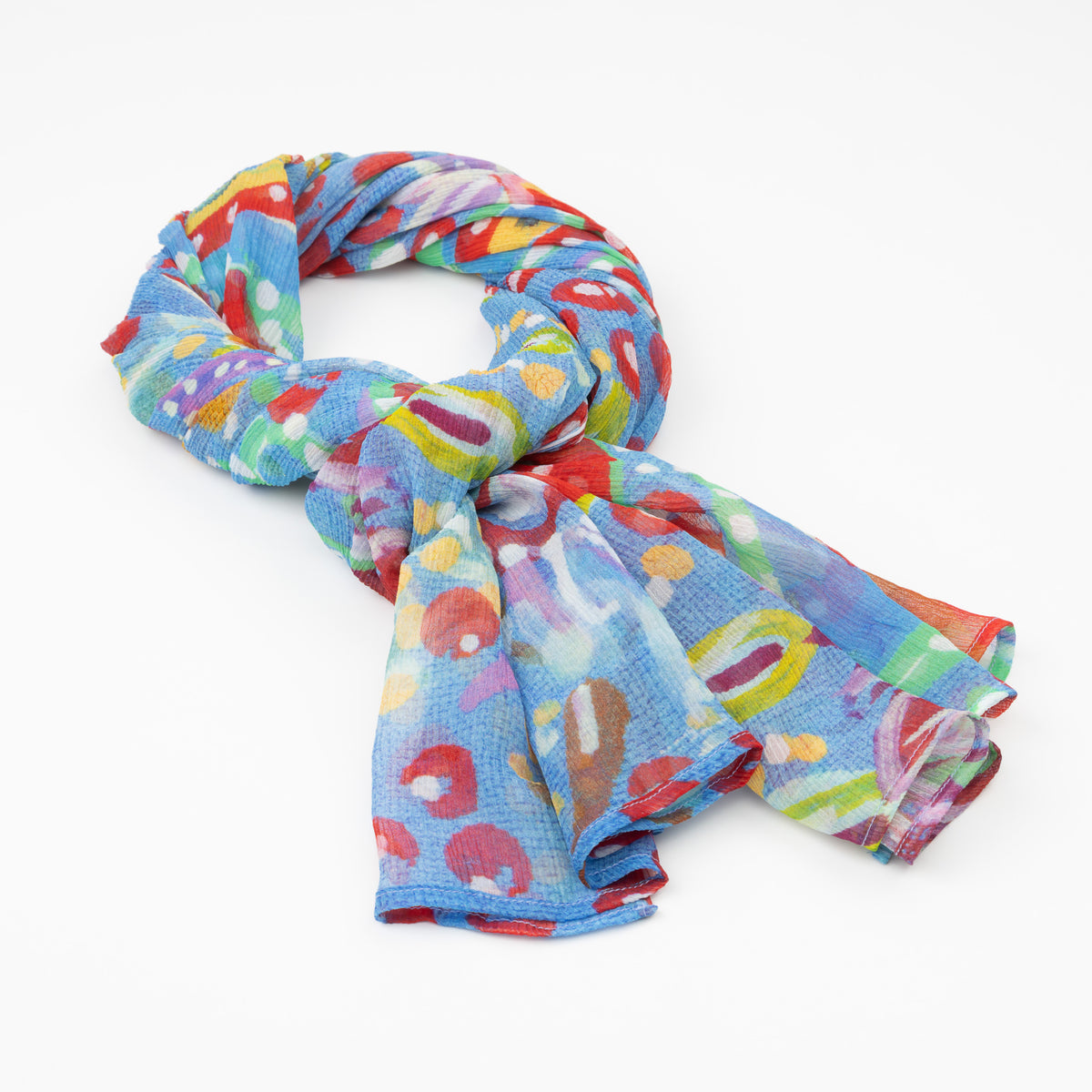 The luxury cashmere scarf with a vibrant Pilbara wildflower design by Sally White, draped in a loose knot.
