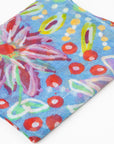 Close up of the folded luxury cashmere scarf with colorful Pilbara wildflower design by Sally White.