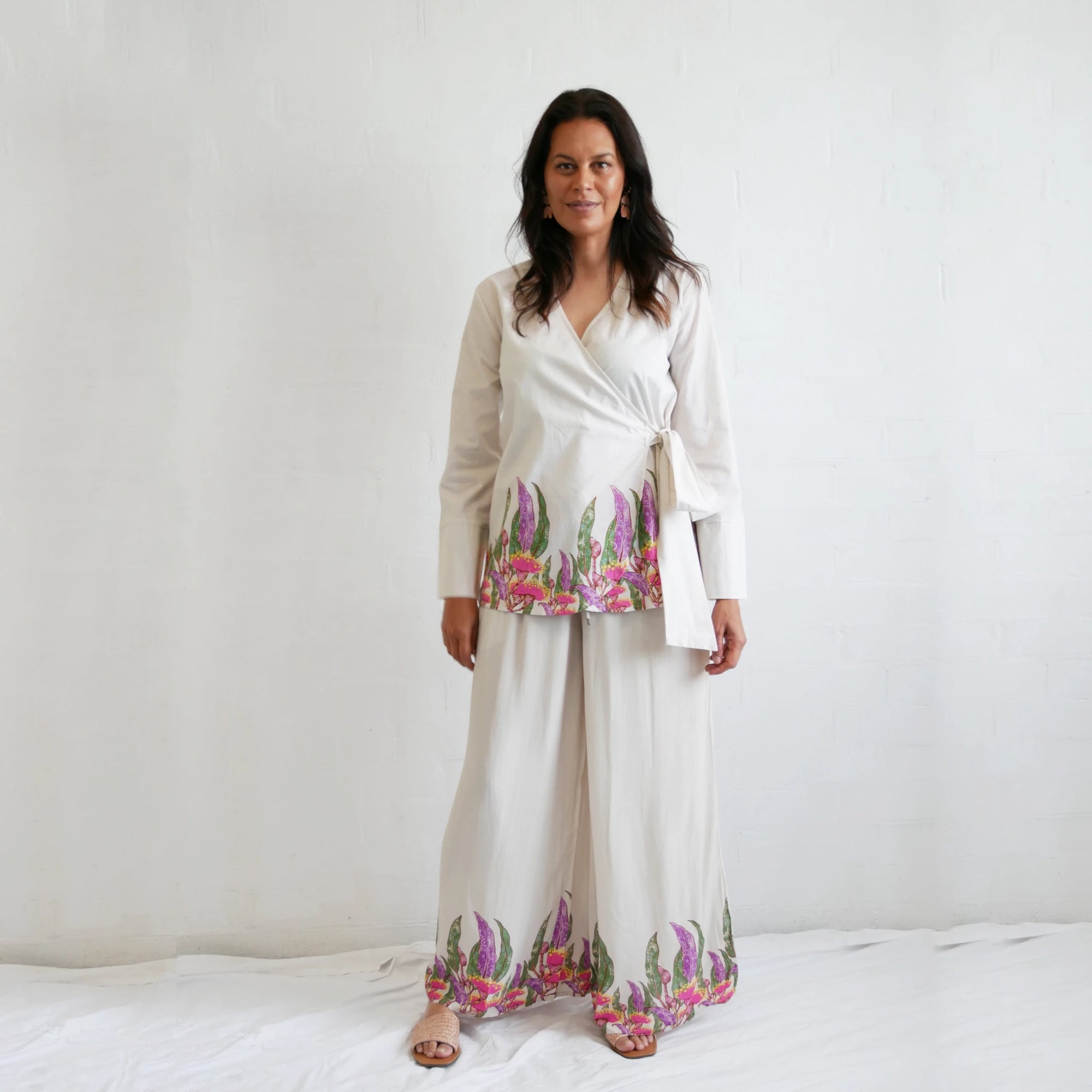 Model wearing the tied Kirrikin Princess Gum wrap blouse in lightweight fabric, showcasing a flattering crossover silhouette and long sleeves.